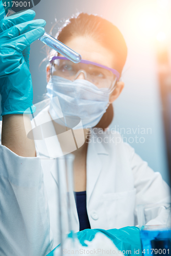 Image of Student puts experiment with reagents