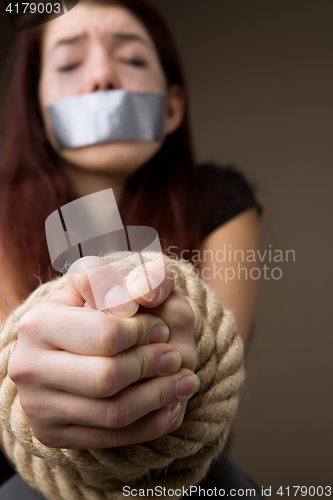 Image of Crying girl with tied hands