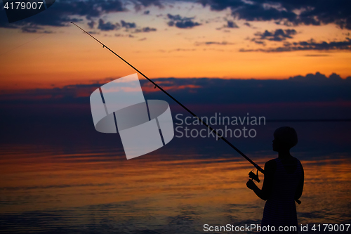 Image of Fishing Silhouette on dramatic sky and sea