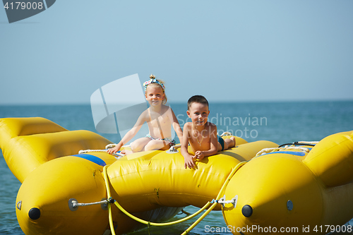Image of two happy kids playing on the boat at summer day