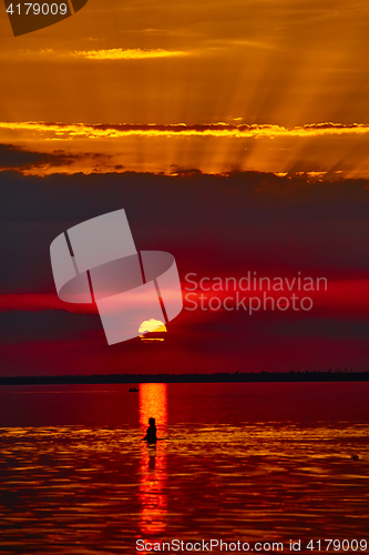 Image of Sunrise in the sea with soft wave and cloudy