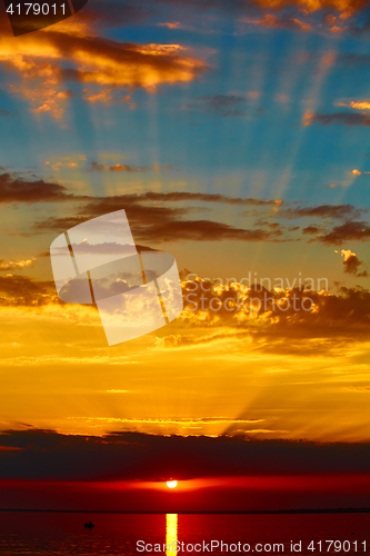 Image of good red sunset over darken sea