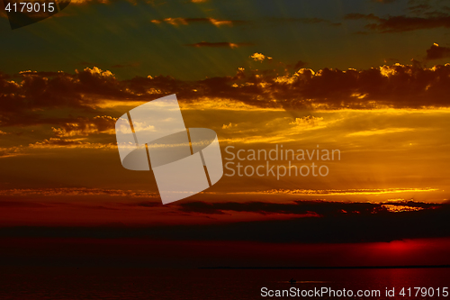 Image of Sunrise in the sea with soft wave and cloudy