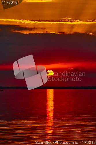 Image of Sunrise in the sea with soft wave and cloudy