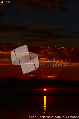 Image of Sunrise in the sea with soft wave and cloudy