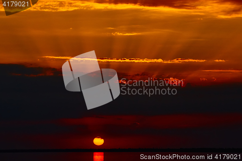 Image of Sunrise in the sea with soft wave and cloudy