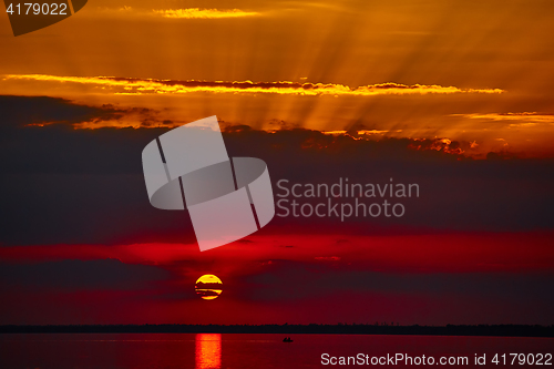 Image of Sunrise in the sea with soft wave and cloudy