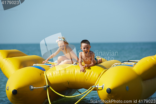 Image of two happy kids playing on the boat at summer day