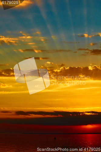 Image of good red sunset over darken sea