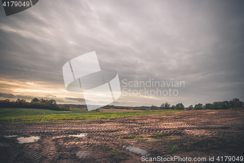 Image of Landscape with wheel tracks on a muddy field