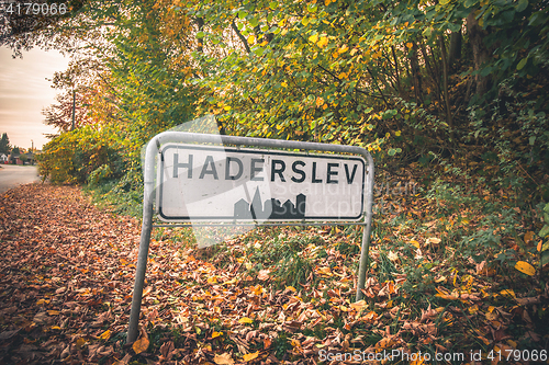 Image of Haderslev city sign by a road in Denmark