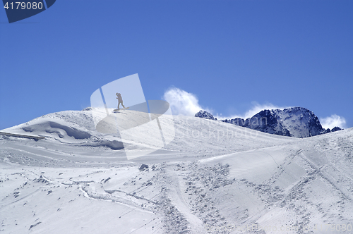 Image of Snowboarder in terrain park at ski resort on sun winter day