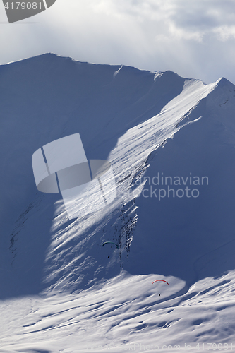 Image of Speed riding in snow mountains at sun evening