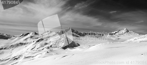 Image of Black and white panorama of snow mountains in winter evening