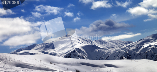 Image of Panoramic view on ski slope and beautiful sky with clouds in sun