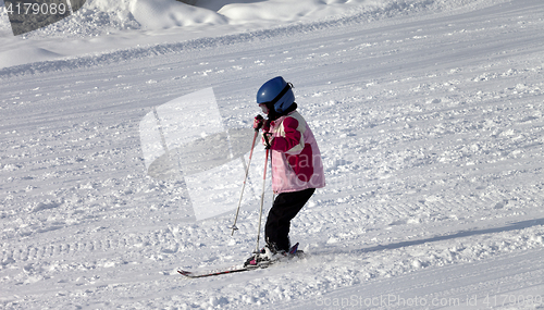 Image of Little skier on ski slope 