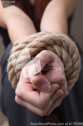 Image of Tied rope hands of girl