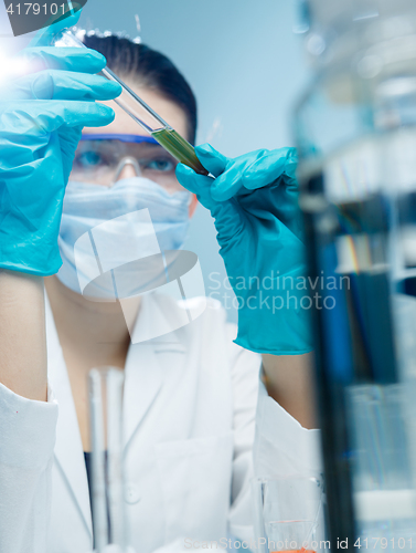 Image of Young researcher working with reagent