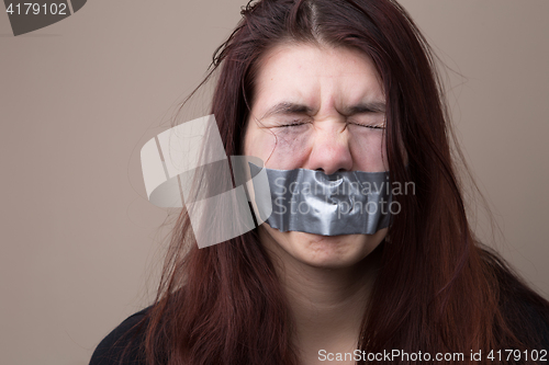 Image of Woman with tape on face