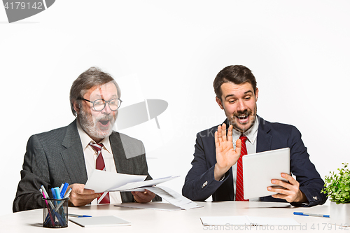 Image of The two colleagues working together at office on white background.