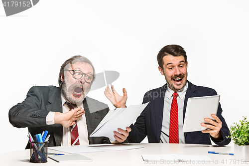 Image of The two colleagues working together at office on white background.