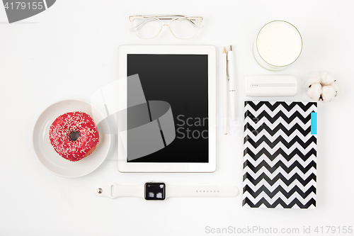 Image of Top view of white office table with laptop