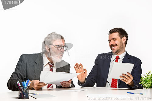 Image of The two colleagues working together at office on white background.