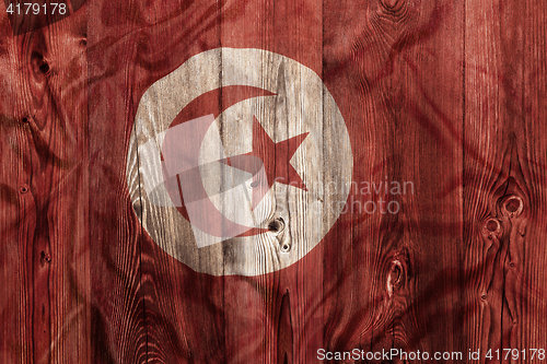 Image of National flag of Tunisia, wooden background