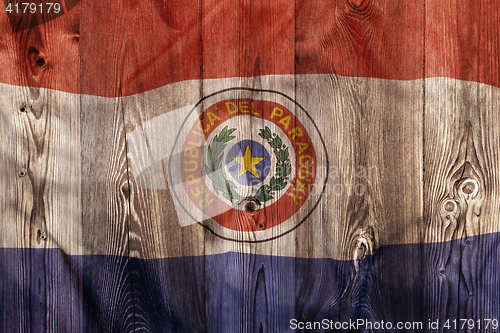 Image of National flag of Paraguay, wooden background