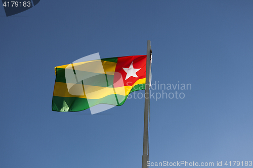 Image of National flag of Togo on a flagpole