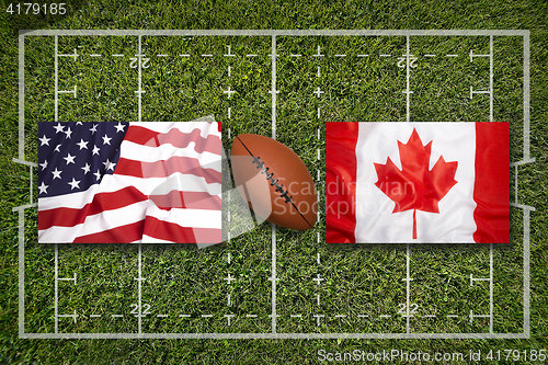 Image of USA vs. Canada flags on rugby field