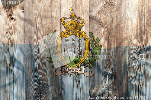 Image of National flag of San Marino, wooden background