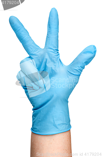 Image of Hand in blue latex glove showing three fingers vertically