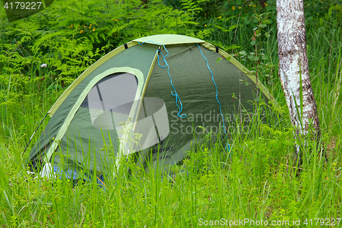 Image of camping outdoor with tent in woods in summer