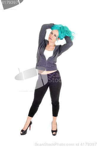 Image of Woman standing with blue hair.