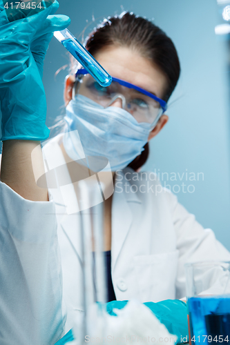 Image of Lab assistant experiments with reagents