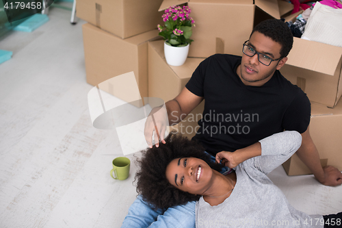 Image of African American couple relaxing in new house