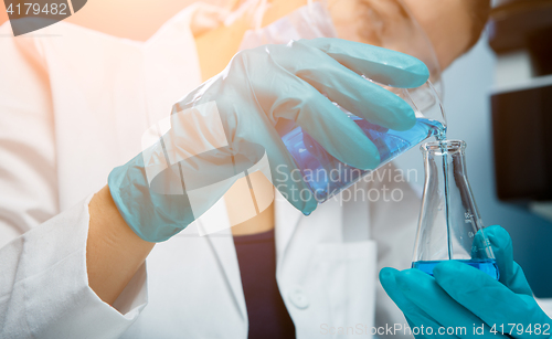 Image of Girl conducts experiments with bulb