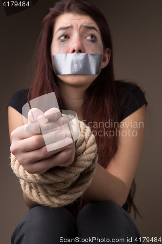 Image of Crying woman with tied hands