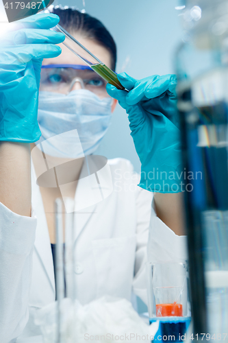 Image of Young scientist working wiht reagent