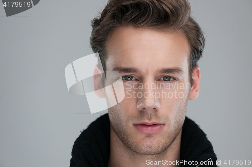 Image of portrait of a young guy over gray background