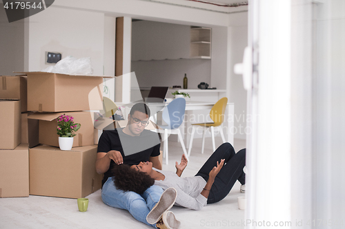 Image of African American couple relaxing in new house