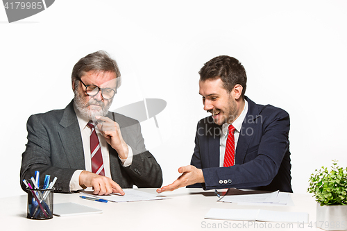 Image of The two colleagues working together at office on white background.