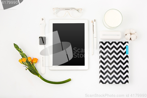 Image of Top view of white office table with laptop