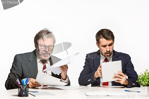 Image of The two colleagues working together at office on white background.