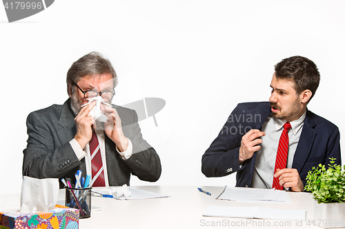 Image of The two colleagues working together at office on white background.