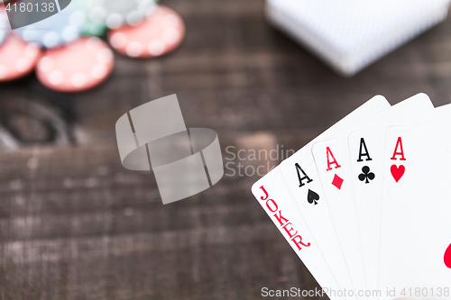 Image of Cards and poker chips on wooden background
