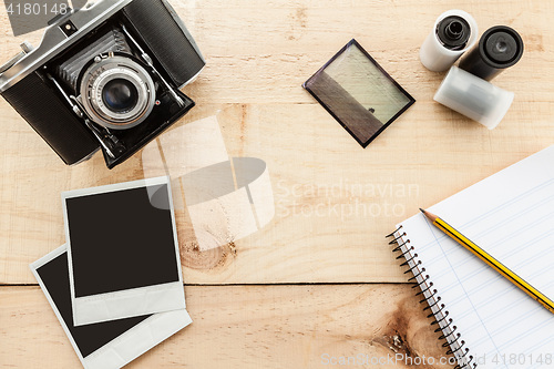 Image of Vintage camera, polaroid films and some traveller stuff