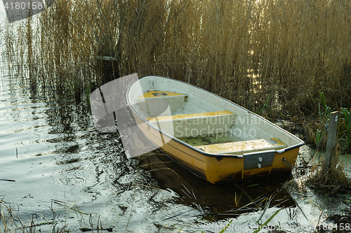 Image of Small boat in a lake in the fall