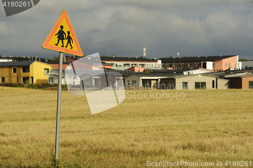 Image of road sign caution children against the village